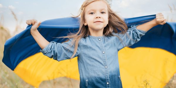 Ukraines Independence Flag Day. Constitution day. Ukrainian child girl in embroidered shirt vyshyvanka with yellow and blue flag of Ukraine in field. flag symbols of Ukraine. Kyiv, Kiev day
